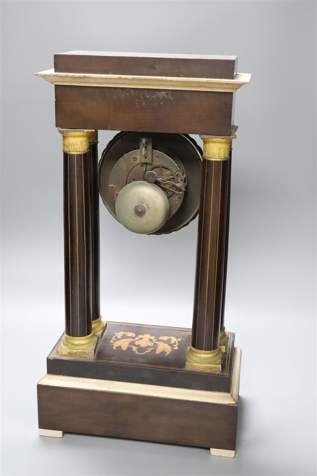 A 19th century inlaid French Portico mantel clock, with cast bacchus pendulum, 49cm